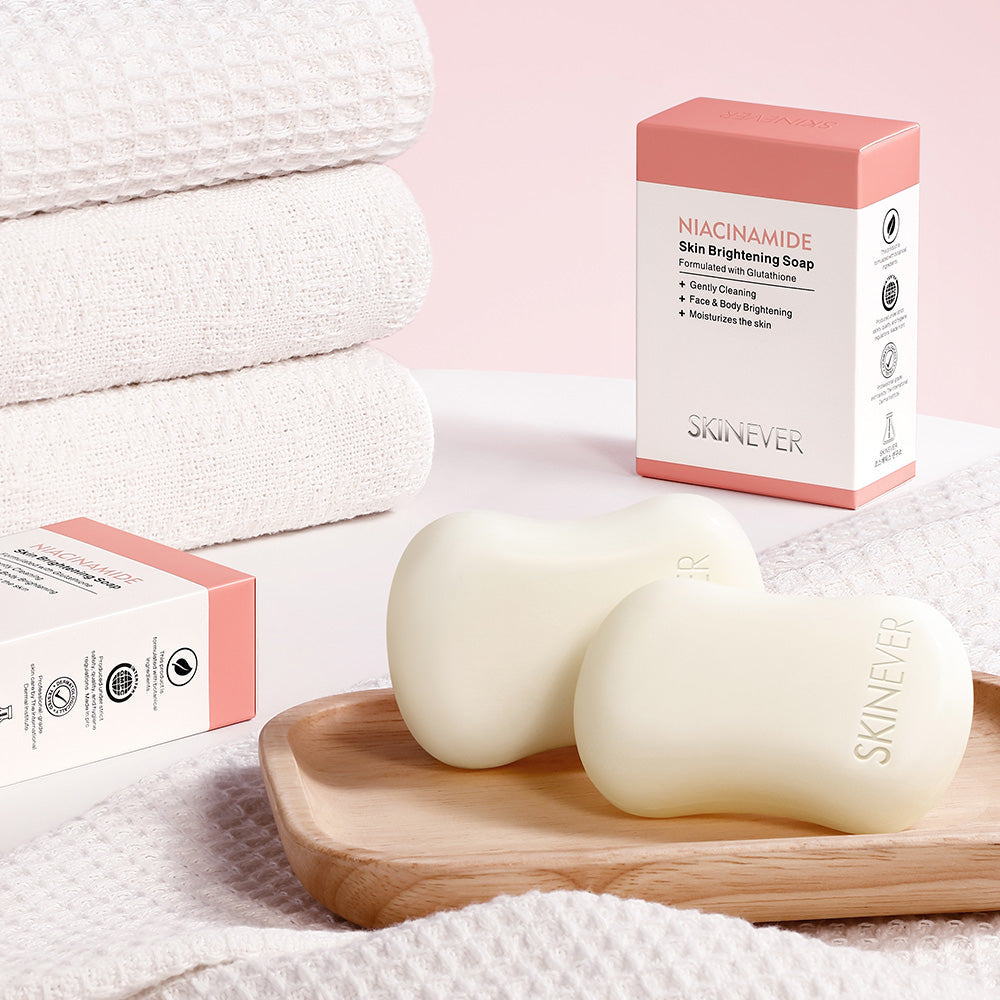 Two Skinever soap bars on a wooden tray with packaging in the background.
