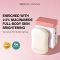 A bar of SKINEVER skin brightening soap in an off-white rounded shape, shown next to its pink and white packaging box. The background is a soft pink, with promotional text highlighting 2.