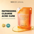 Orange body wash container with 'SKINEVER' branding on a beige background