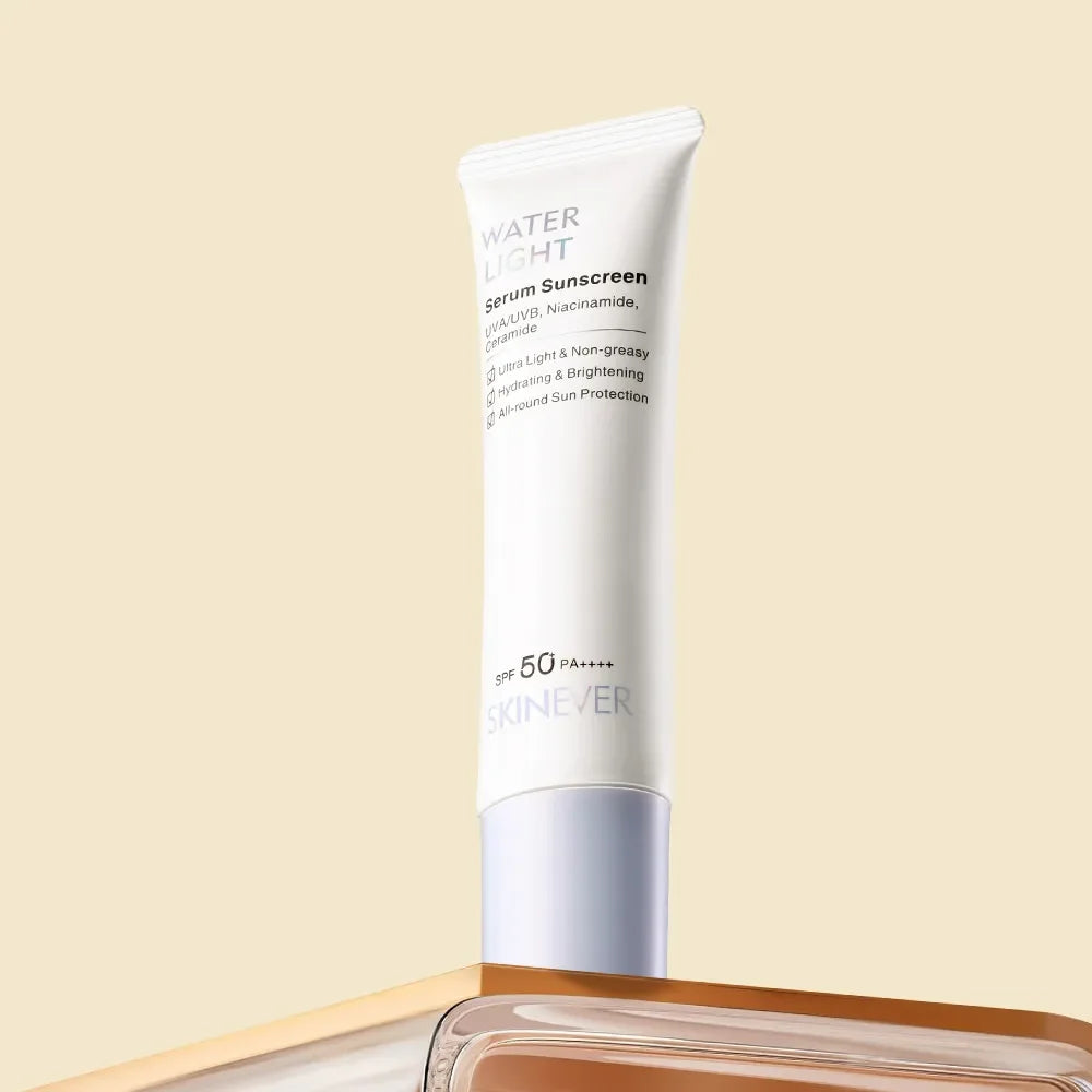 A white tube of SKINEVER Water Light Serum Sunscreen SPF 50 PA++++ stands upright on a reflective surface against a solid beige background.